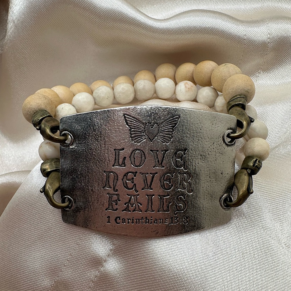 Lenny and Eva beaded bracelet with “love never fails” Bible verse plaque 7.5 in
